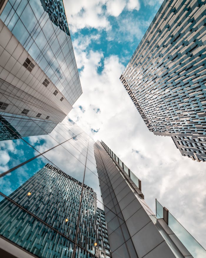 low-angle-photography-of-glass-buildings-2529179 Low angle view of modern skyscrapers reflecting the cloudy sky in Brussels, Belgium.